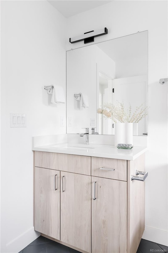 bathroom featuring tile patterned flooring, baseboards, and vanity