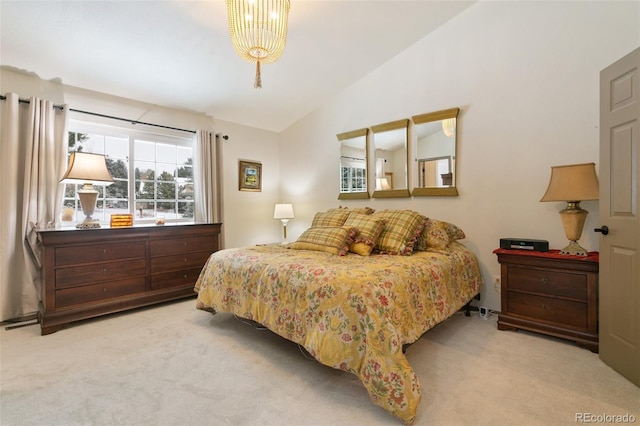 bedroom with lofted ceiling and light carpet