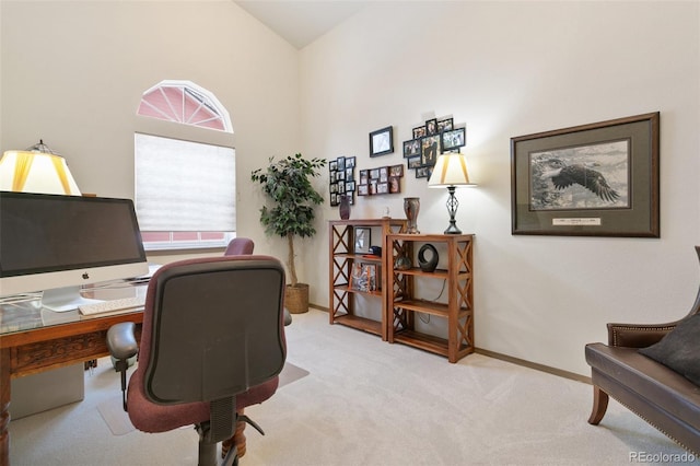 office space featuring light colored carpet and vaulted ceiling