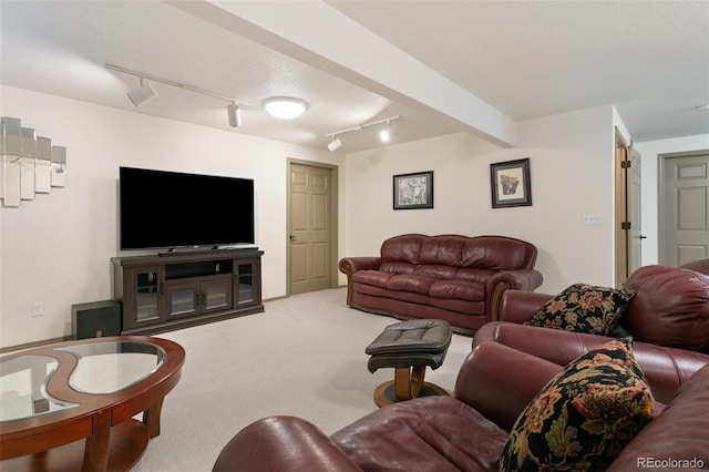 living room with beamed ceiling, carpet floors, and track lighting