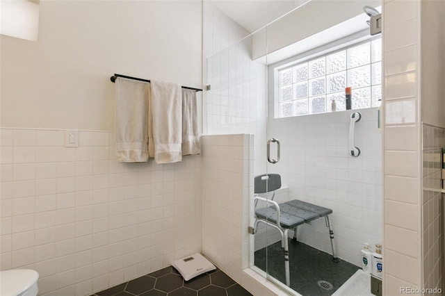 6545 Bonifas Ct, Colorado Springs, CO 80919 - full bath featuring tile patterned flooring, a stall shower, toilet, and tile walls