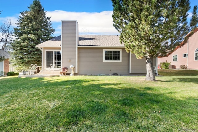 6545 Bonifas Ct, Colorado Springs, CO 80919 - back of property featuring a shingled roof, a yard, and a chimney
