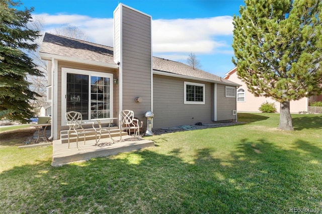 6545 Bonifas Ct, Colorado Springs, CO 80919 - back of property with a yard, roof with shingles, a chimney, and entry steps