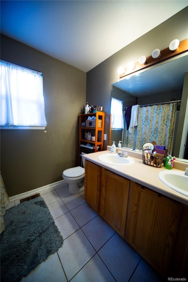 9950 Sydney Ln, Highlands Ranch, CO 80130 - full bath featuring double vanity, toilet, and tile patterned flooring