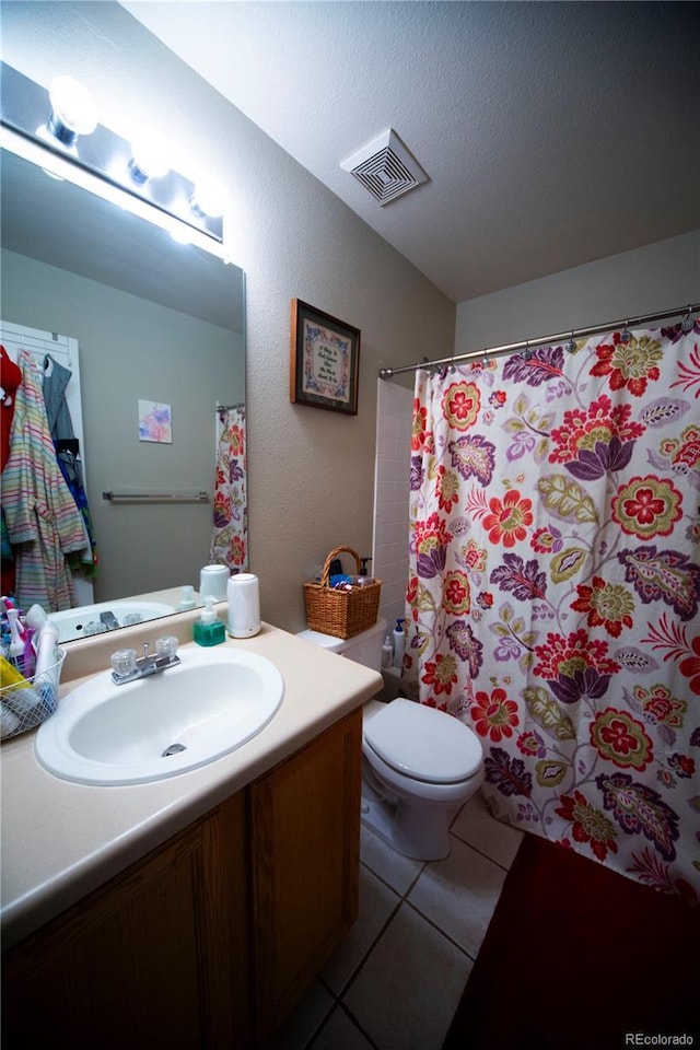 9950 Sydney Ln, Highlands Ranch, CO 80130 - full bathroom featuring vanity, toilet, and tile patterned flooring