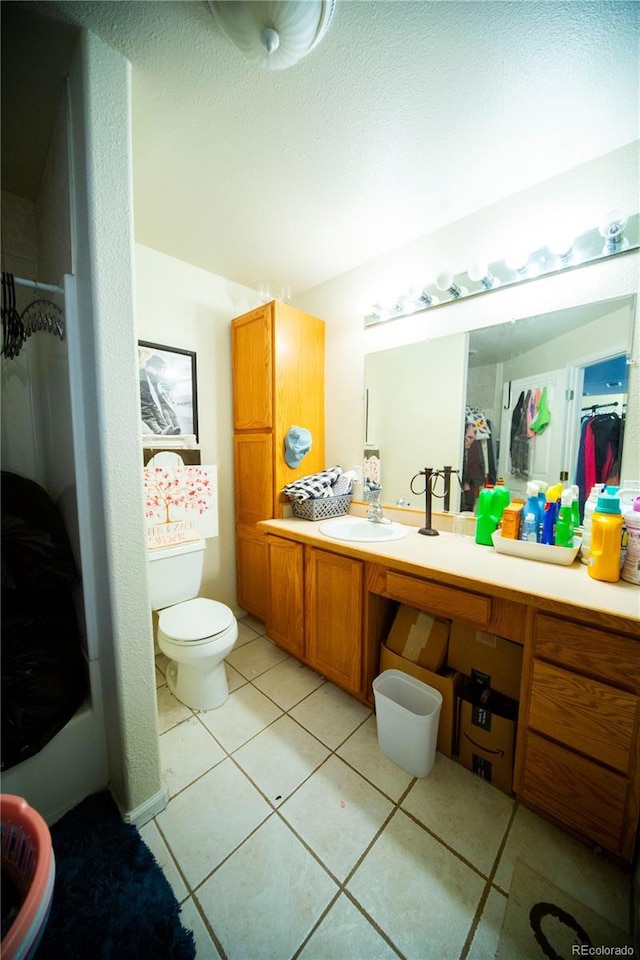 9950 Sydney Ln, Highlands Ranch, CO 80130 - full bathroom featuring vanity, toilet, tile patterned floors, and a shower
