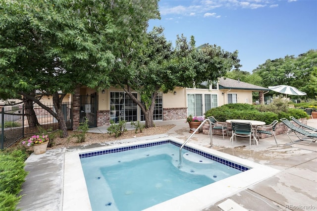 view of swimming pool with a patio and fence