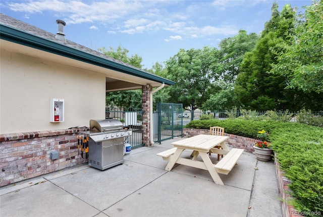 view of patio / terrace featuring a grill, outdoor dining space, and fence