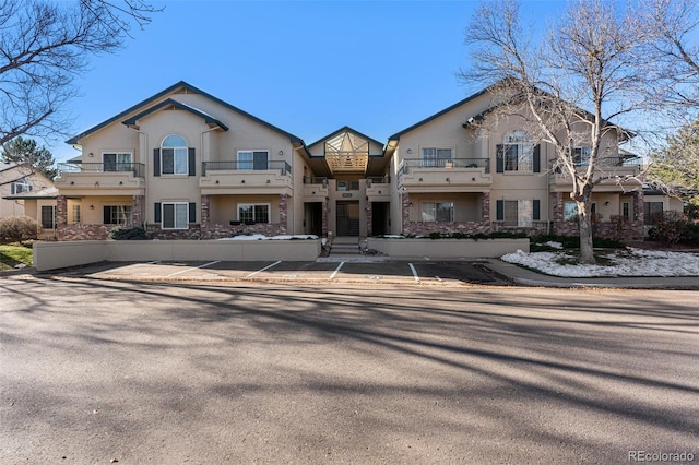 view of front of property with a balcony and stucco siding