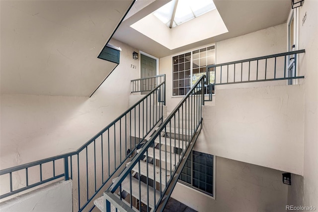 staircase featuring a skylight