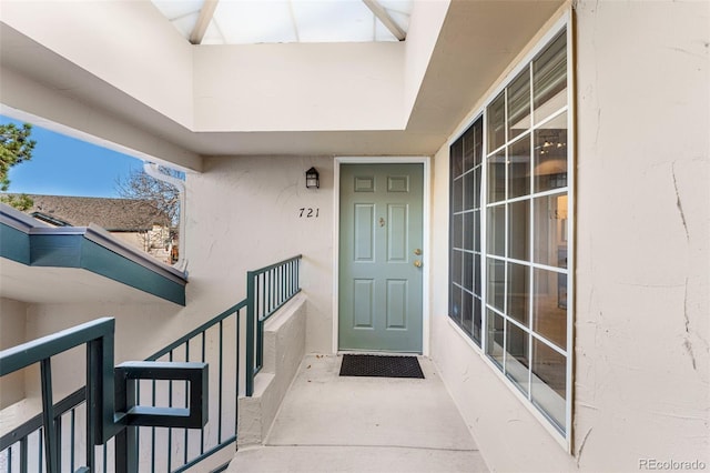 entrance to property featuring stucco siding