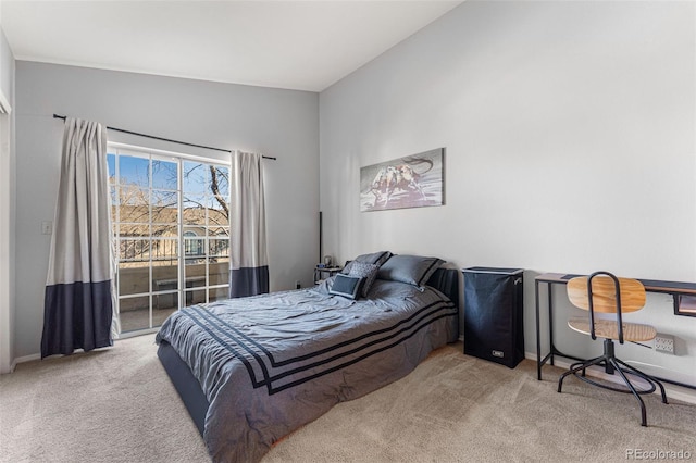 carpeted bedroom with baseboards and access to outside