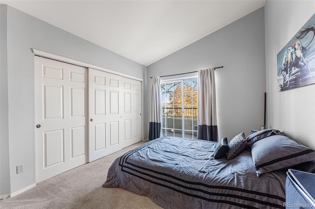 carpeted bedroom featuring a closet and vaulted ceiling