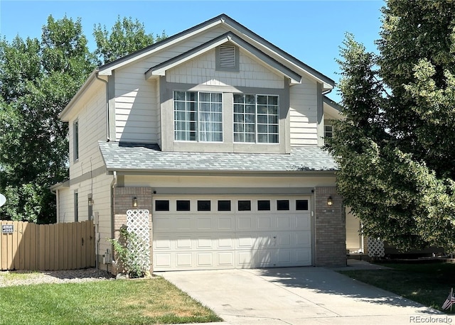 view of front facade with a garage, concrete driveway, brick siding, and fence