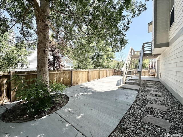 view of patio / terrace with a fenced backyard and stairway