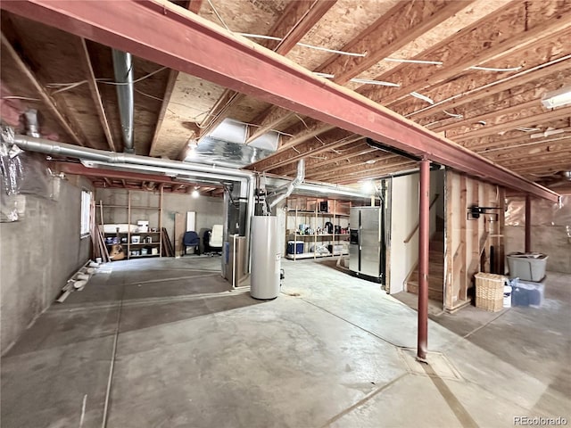 unfinished basement with stainless steel fridge, stairs, and gas water heater