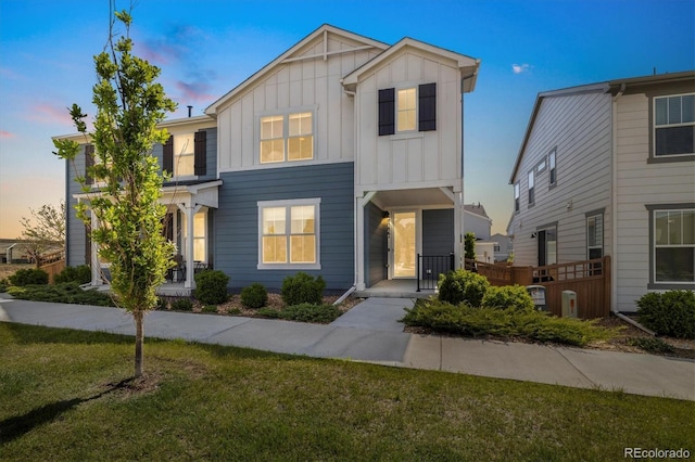8586 Holman Ct Unit A, Arvada, CO 80005 - view of property featuring board and batten siding and a yard