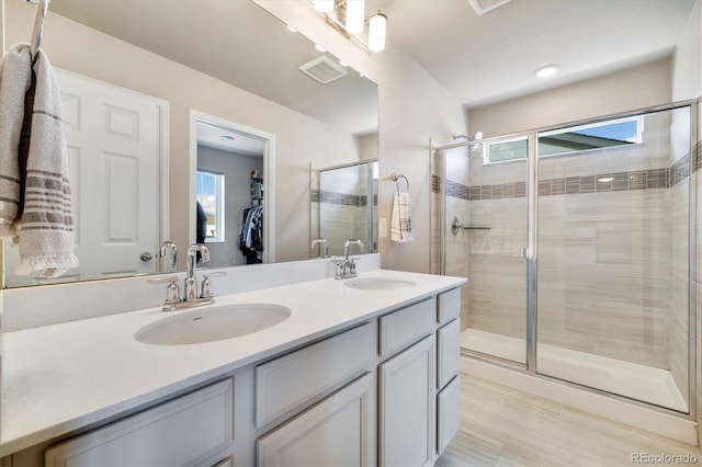 8586 Holman Ct Unit A, Arvada, CO 80005 - full bathroom with a shower stall, double vanity, and a spacious closet