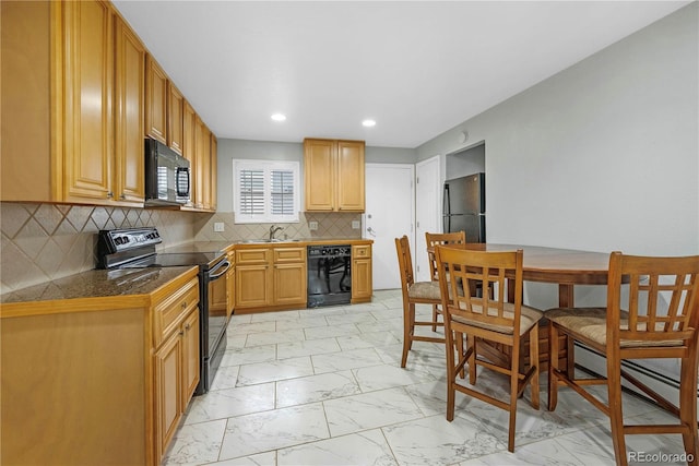 kitchen with black appliances and tasteful backsplash