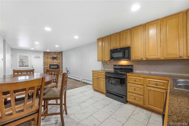 2190 S Holly St Unit 207, Denver, CO 80222 - kitchen featuring black appliances, decorative backsplash, a fireplace, sink, and a baseboard heating unit