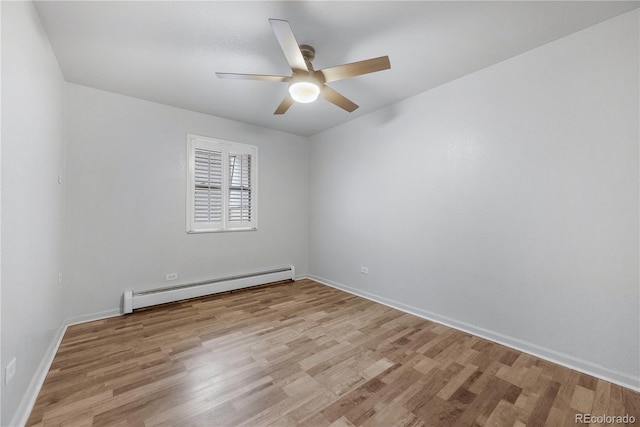 2190 S Holly St Unit 207, Denver, CO 80222 - spare room featuring ceiling fan, light wood-type flooring, and a baseboard radiator