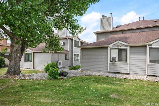 10212 W 80th Dr Unit C, Arvada, CO 80005 - back of house with a lawn and a chimney
