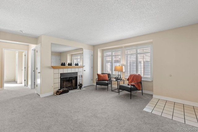 10212 W 80th Dr Unit C, Arvada, CO 80005 - sitting room with carpet, a tiled fireplace, and a textured ceiling