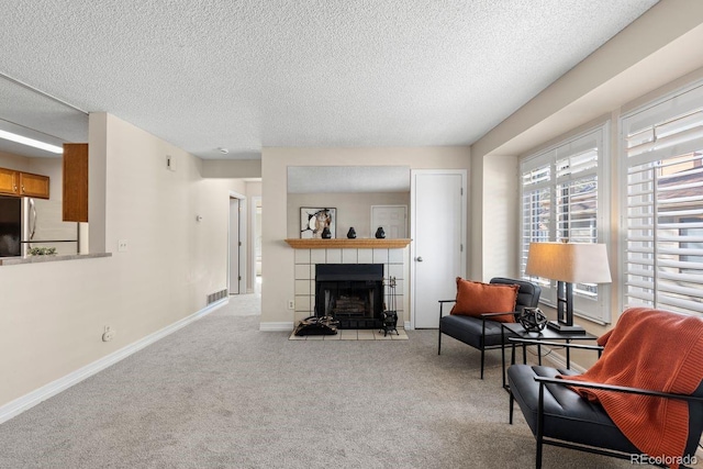 10212 W 80th Dr Unit C, Arvada, CO 80005 - carpeted living room featuring a fireplace and a textured ceiling