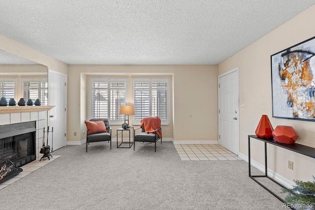 10212 W 80th Dr Unit C, Arvada, CO 80005 - living area with carpet floors, a textured ceiling, a tiled fireplace, and tile patterned floors