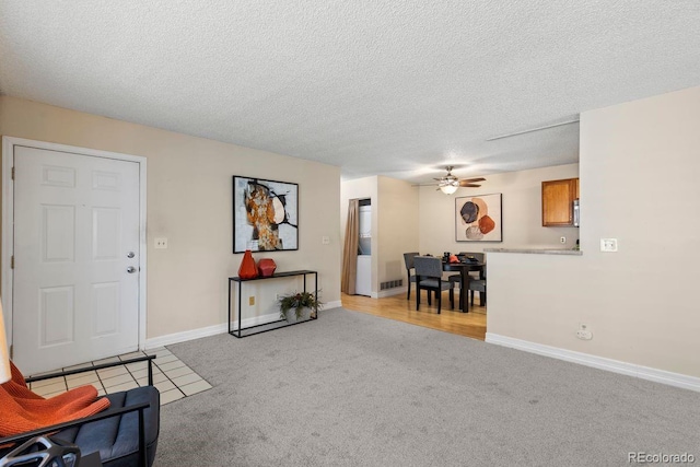 10212 W 80th Dr Unit C, Arvada, CO 80005 - living room featuring light colored carpet, a ceiling fan, and a textured ceiling
