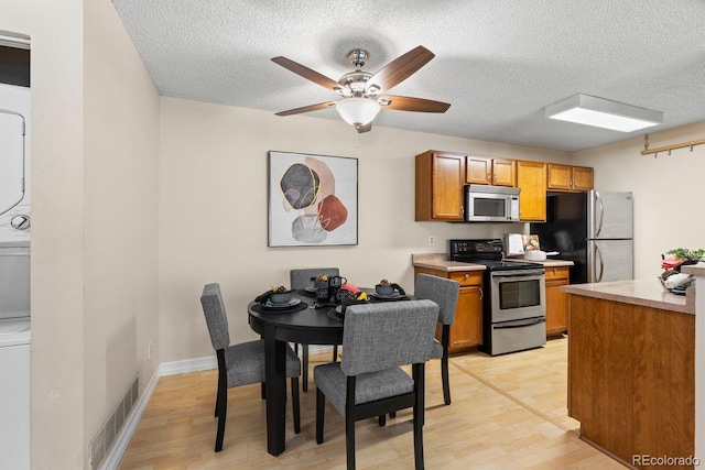 10212 W 80th Dr Unit C, Arvada, CO 80005 - kitchen featuring appliances with stainless steel finishes, a textured ceiling, light countertops, light wood-type flooring, and ceiling fan