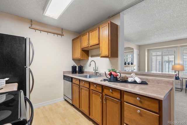 10212 W 80th Dr Unit C, Arvada, CO 80005 - kitchen featuring range with electric stovetop, stainless steel dishwasher, freestanding refrigerator, brown cabinetry, and light countertops
