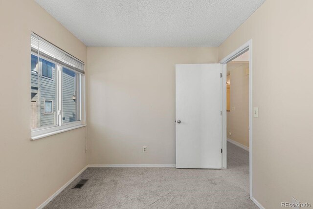 10212 W 80th Dr Unit C, Arvada, CO 80005 - unfurnished bedroom featuring a textured ceiling and carpet