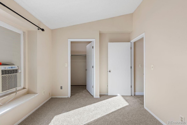 10212 W 80th Dr Unit C, Arvada, CO 80005 - unfurnished bedroom with carpet flooring, vaulted ceiling, and a walk in closet