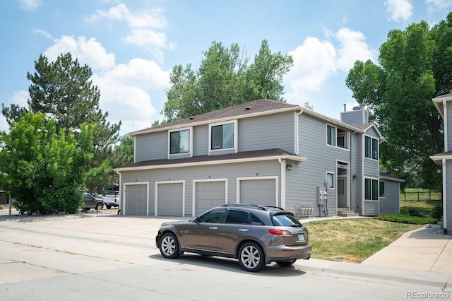 10212 W 80th Dr Unit C, Arvada, CO 80005 - view of front of house featuring concrete driveway, an attached garage, and entry steps