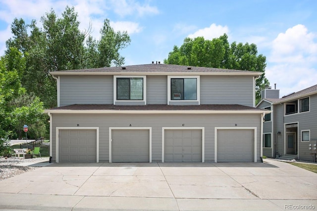 10212 W 80th Dr Unit C, Arvada, CO 80005 - view of front facade featuring a garage and concrete driveway