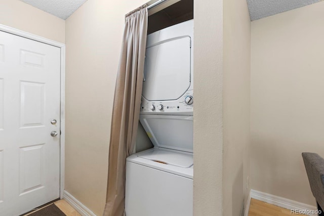 10212 W 80th Dr Unit C, Arvada, CO 80005 - washroom with stacked washer / drying machine and a textured ceiling