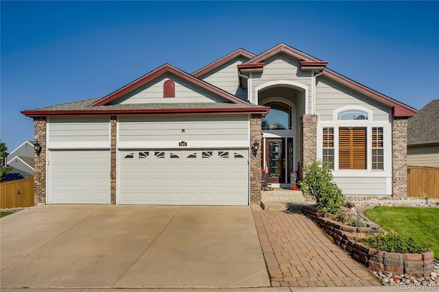 9451 Desert Willow Trl, Highlands Ranch, CO 80129 - view of front of house featuring driveway, a garage, and brick siding