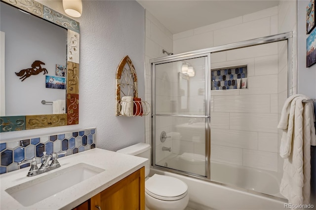 9451 Desert Willow Trl, Highlands Ranch, CO 80129 - full bathroom with a textured wall, toilet, vanity, tasteful backsplash, and enclosed tub / shower combo