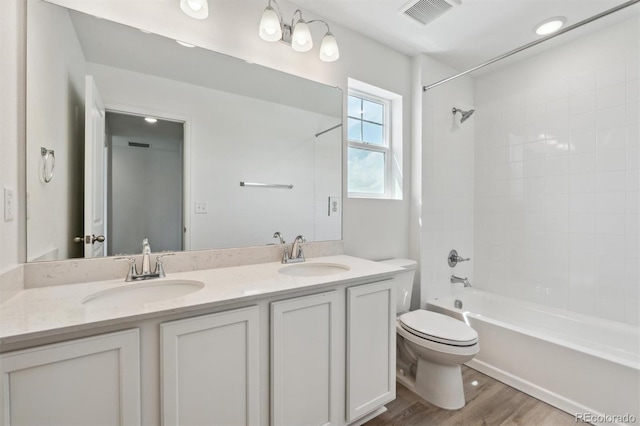 9672 Cathay St, Commerce City, CO 80022 - full bathroom with toilet, wood finished floors, a sink, and visible vents