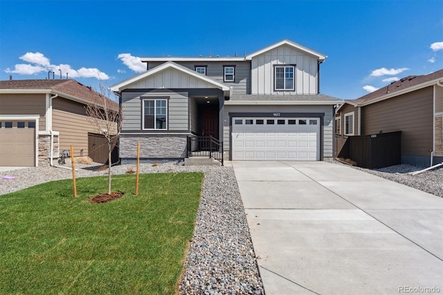 9672 Cathay St, Commerce City, CO 80022 - view of front of home featuring board and batten siding, an attached garage, driveway, and fence