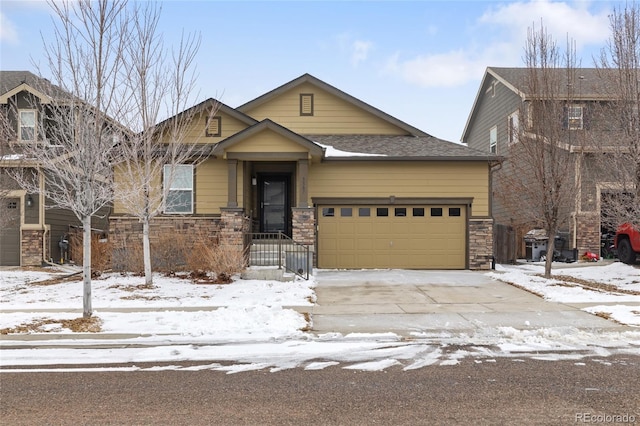 craftsman-style house with a garage, stone siding, roof with shingles, and concrete driveway