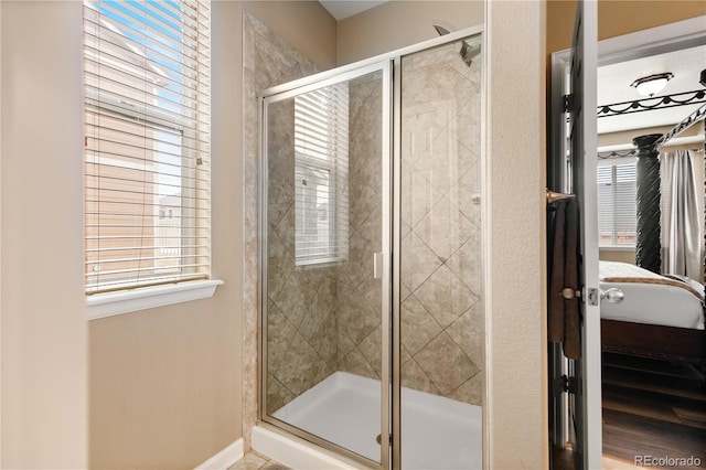 bathroom featuring a healthy amount of sunlight and an enclosed shower