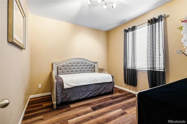 bedroom with dark hardwood / wood-style floors