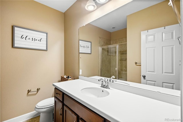 bathroom featuring vanity, an enclosed shower, and toilet