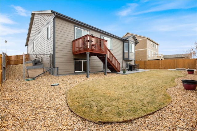 back of property with a deck and a patio area