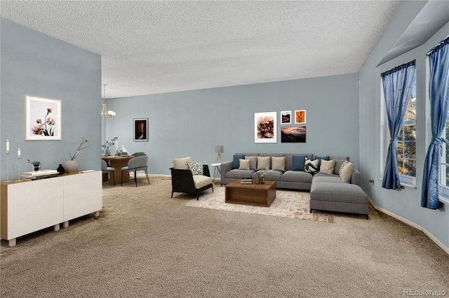 living room featuring carpet floors, a chandelier, and a textured ceiling