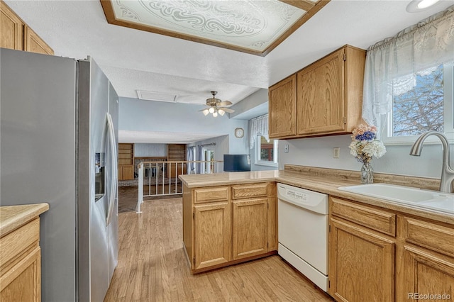 kitchen featuring stainless steel fridge with ice dispenser, sink, white dishwasher, kitchen peninsula, and light wood-type flooring