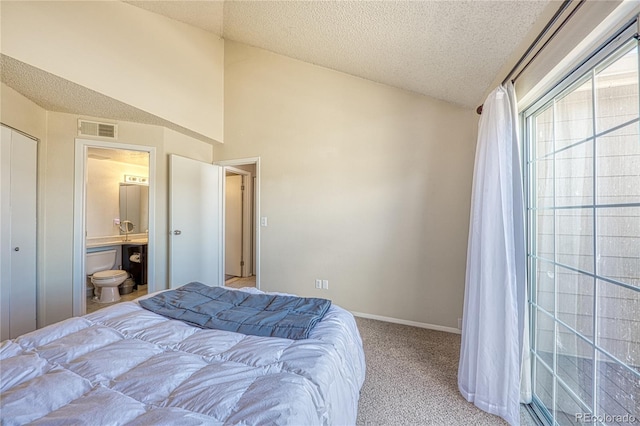 4760 S Wadsworth Blvd Unit 302, Littleton, CO 80123 - bedroom featuring a textured ceiling, carpet flooring, lofted ceiling, baseboards, and ensuite bath