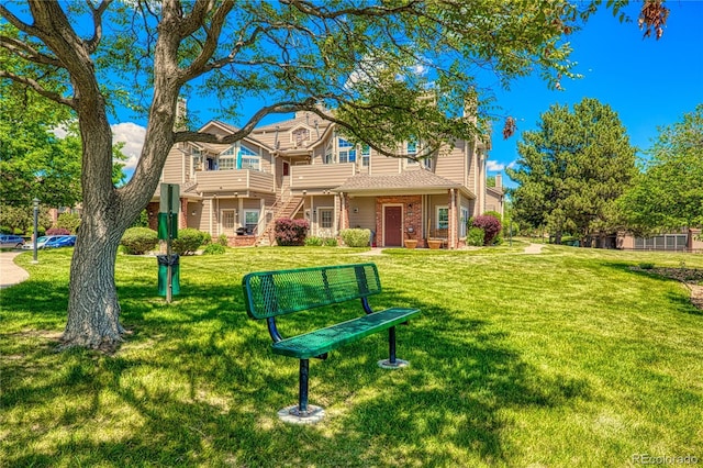 4760 S Wadsworth Blvd Unit 302, Littleton, CO 80123 - rear view of property featuring a yard and brick siding